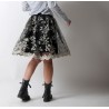 Short pleated skirt in black tulle with white lacy embroidery
