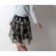 Short pleated skirt in black tulle with white lacy embroidery