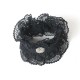 Short black bracelet cuffs, lace ruffles and rhinestone