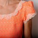 Short sleeved neon orange top, beige lace collar
