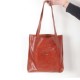 Burnt orange varnished leather shopping tote bag, with two pockets