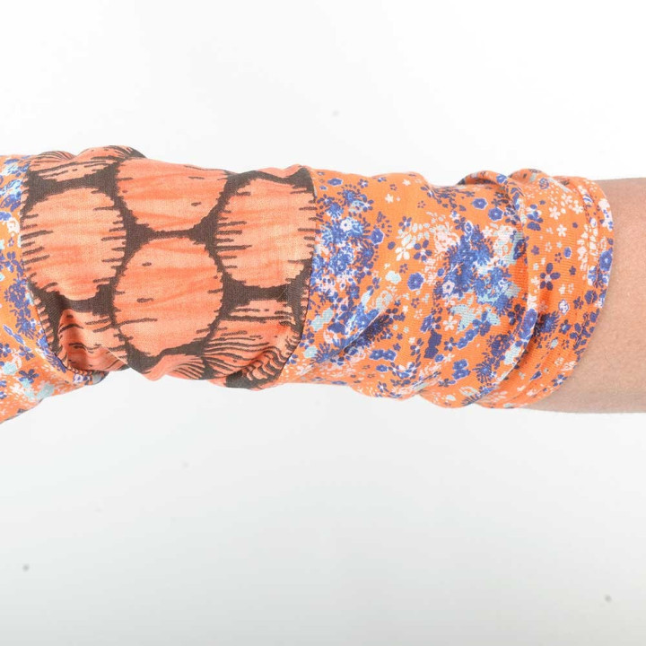 Colorful armwarmers in a patchwork of orange printed jersey