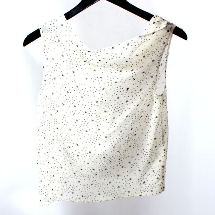 Women’s white and black sleeveless designer top combining sheer fabric and an easy flowing shape